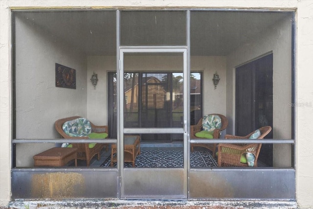 entrance to property featuring stucco siding