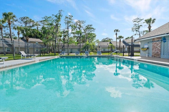 community pool with fence and a residential view