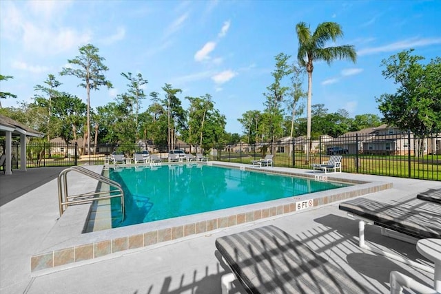 pool with fence and a patio area