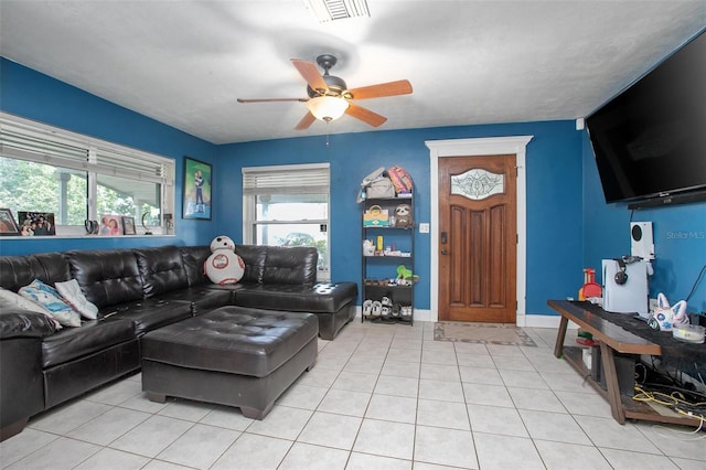 living room featuring a ceiling fan, visible vents, and light tile patterned flooring