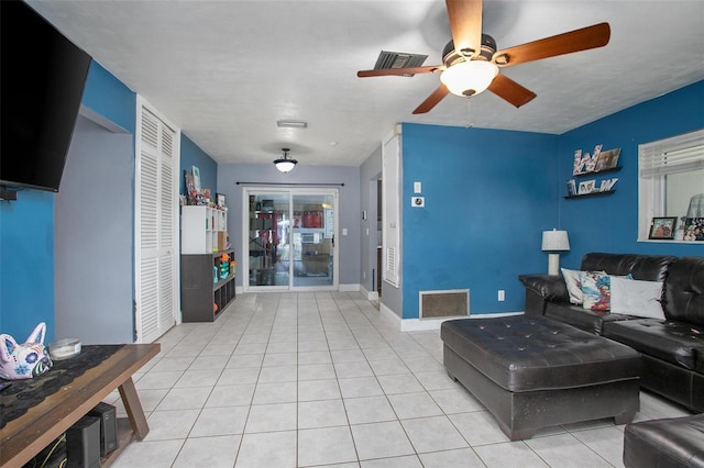 tiled living area featuring visible vents, baseboards, and ceiling fan
