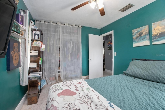 bedroom featuring baseboards, ceiling fan, a closet, and visible vents