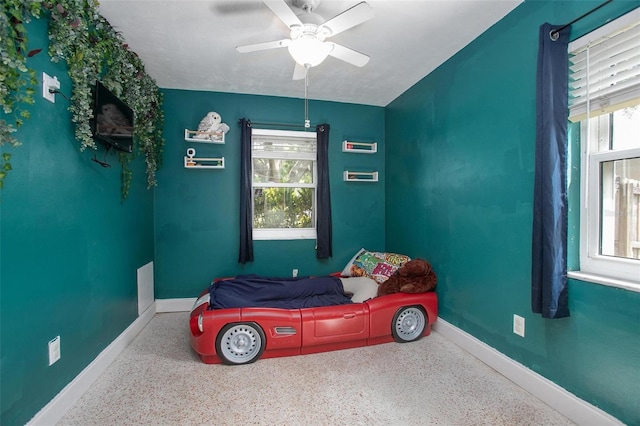 bedroom with baseboards, a ceiling fan, and speckled floor