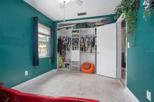 recreation room featuring a ceiling fan, baseboards, visible vents, and speckled floor