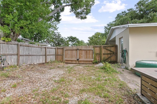 view of yard featuring fence and a gate