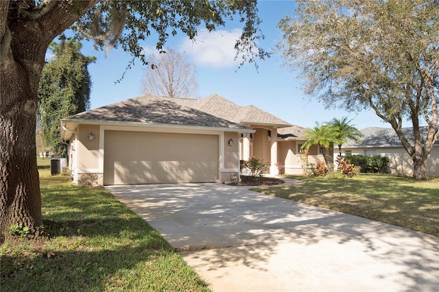 single story home with a garage, a front lawn, stucco siding, and driveway