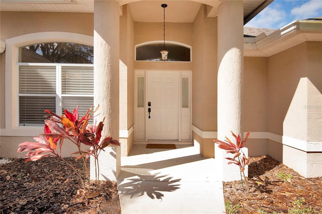 entrance to property with stucco siding
