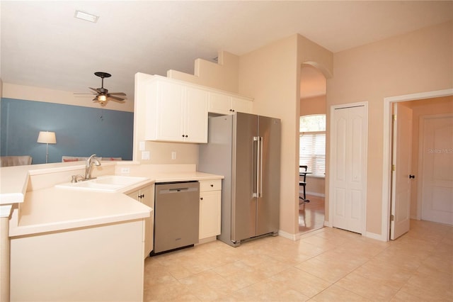 kitchen with stainless steel appliances, ceiling fan, a sink, white cabinetry, and a peninsula