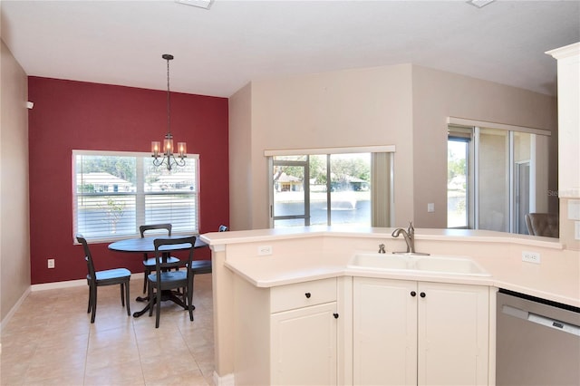 kitchen featuring a sink, dishwasher, a peninsula, and light countertops