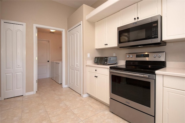kitchen with white cabinets, a toaster, appliances with stainless steel finishes, and light countertops