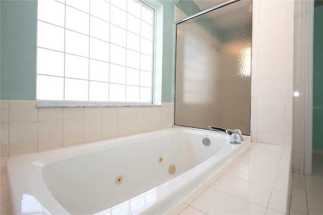 bathroom featuring a tub with jets and a shower stall