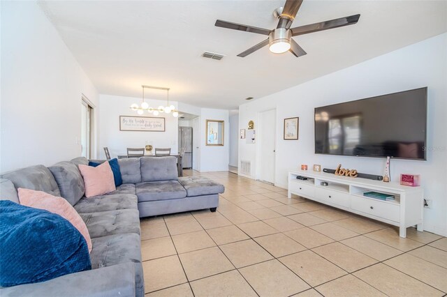 1343 Rocky Rd, Kissimmee, FL 34744 - living room featuring light tile patterned flooring, visible vents, and ceiling fan with notable chandelier
