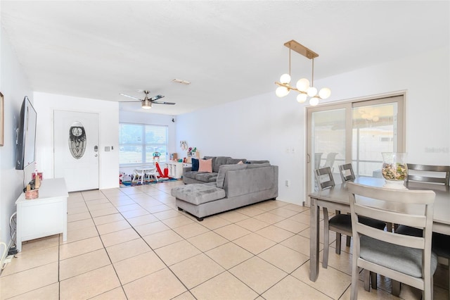 1343 Rocky Rd, Kissimmee, FL 34744 - dining area with light tile patterned floors, visible vents, and ceiling fan with notable chandelier