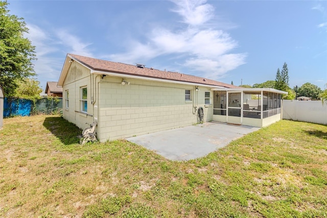 1343 Rocky Rd, Kissimmee, FL 34744 - rear view of property with a sunroom, a yard, a fenced backyard, and a patio area