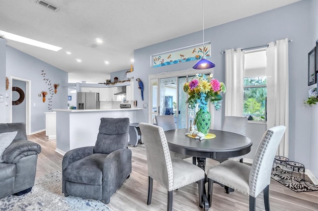 dining area with light wood-type flooring, recessed lighting, baseboards, and visible vents