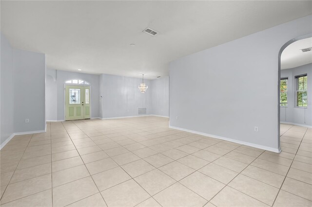 8231 SW 79th Ct, Ocala, FL 34476 - empty room featuring light tile patterned floors, visible vents, a notable chandelier, and arched walkways