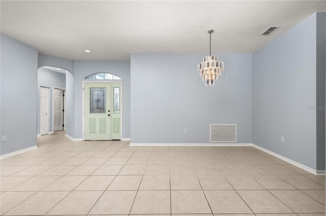 8231 SW 79th Ct, Ocala, FL 34476 - spare room featuring arched walkways, visible vents, a chandelier, and baseboards