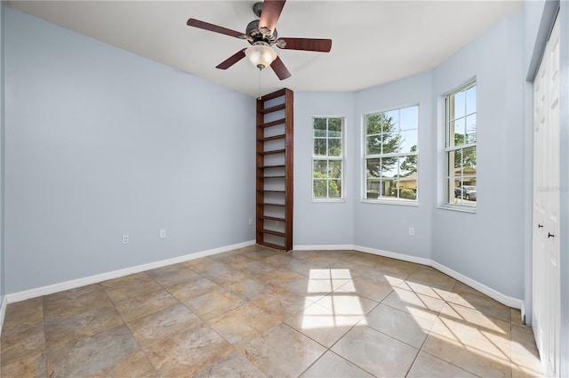 8231 SW 79th Ct, Ocala, FL 34476 - spare room with baseboards and a ceiling fan