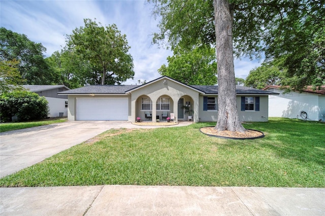 ranch-style house with a garage, stucco siding, a front yard, and concrete driveway