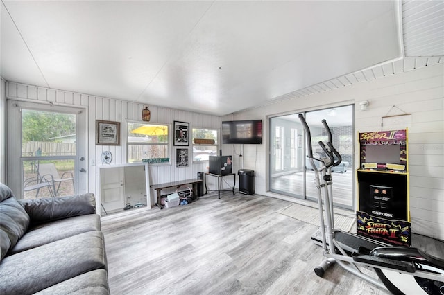 workout area with wood walls and wood finished floors