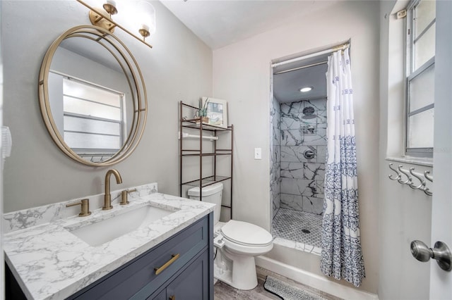 bathroom with toilet, a stall shower, wood finished floors, and vanity