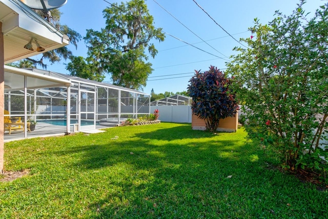 view of yard featuring a storage unit, a fenced backyard, an outdoor structure, and a fenced in pool