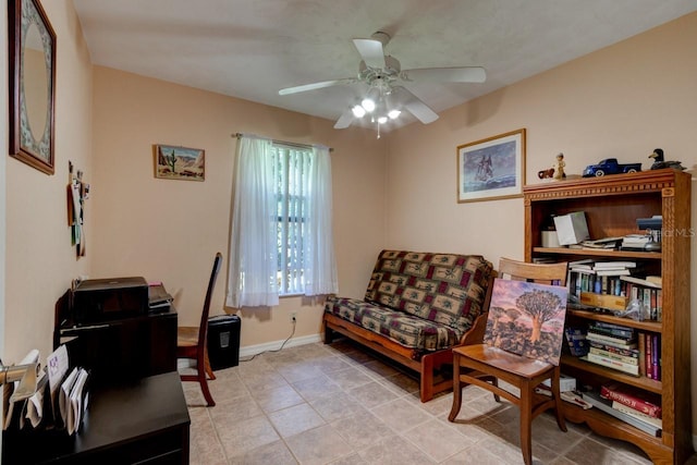 sitting room with light tile patterned flooring, ceiling fan, and baseboards