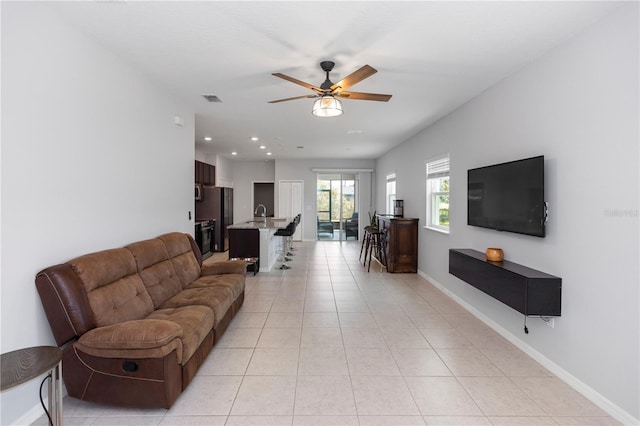 living room featuring visible vents, light tile patterned flooring, baseboards, recessed lighting, and a ceiling fan