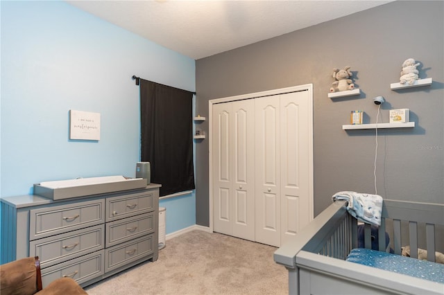 bedroom featuring light colored carpet and a closet