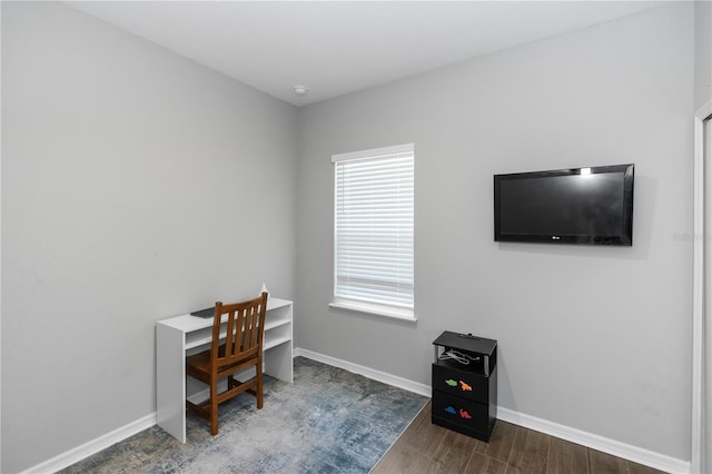 office area featuring baseboards and wood finished floors
