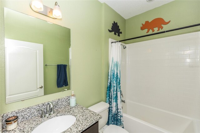 full bath with vanity, shower / bath combo, and toilet