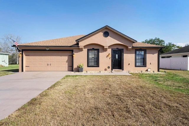 ranch-style house with a garage, stucco siding, a front yard, and concrete driveway
