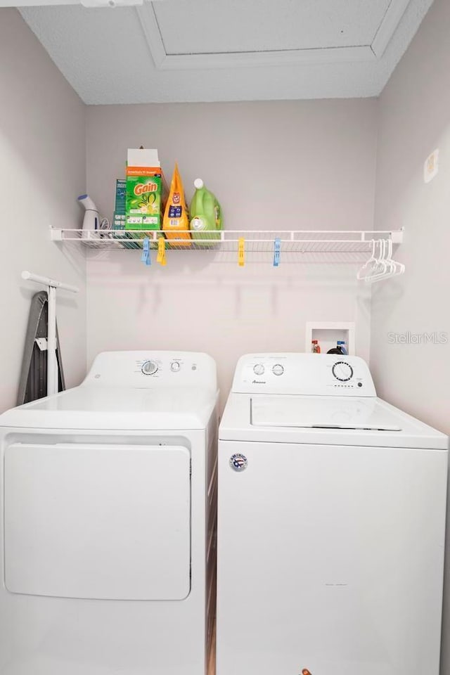 washroom with laundry area and washer and dryer