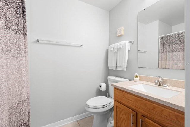 full bath featuring toilet, baseboards, tile patterned flooring, and vanity
