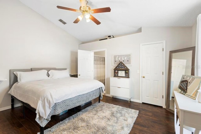 bedroom with visible vents, dark wood-style flooring, lofted ceiling, baseboards, and a ceiling fan