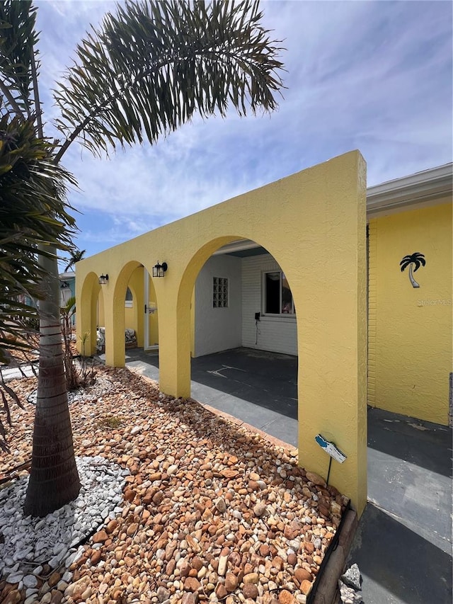 855 Boca Ciega Isle Dr, St Pete Beach, FL 33706 - exterior space with a patio and stucco siding