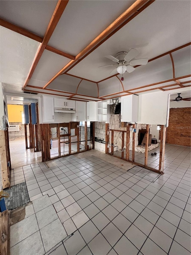855 Boca Ciega Isle Dr, St Pete Beach, FL 33706 - interior space with light tile patterned floors, ceiling fan, a fireplace, and wood walls