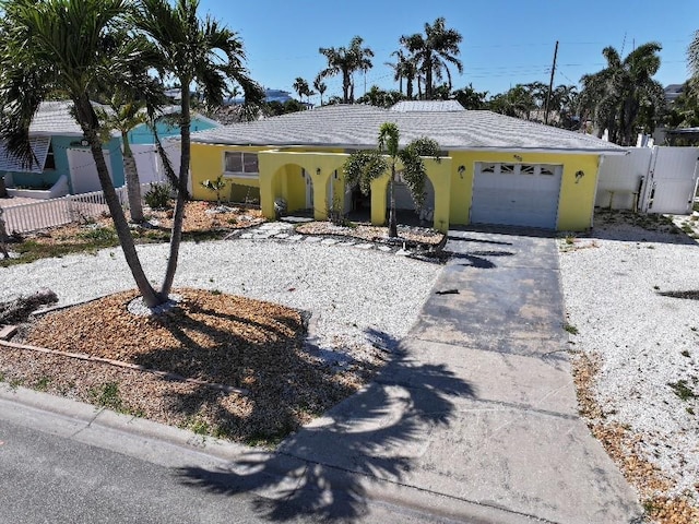 855 Boca Ciega Isle Dr, St Pete Beach, FL 33706 - single story home with stucco siding, aphalt driveway, fence, and a garage