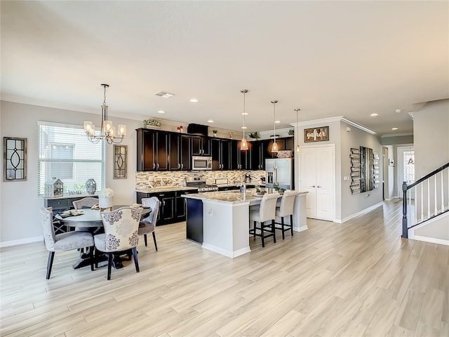260 Teddy Rushing St, Debary, FL 32713 - kitchen featuring an inviting chandelier, a kitchen bar, plenty of natural light, backsplash, and stainless steel appliances