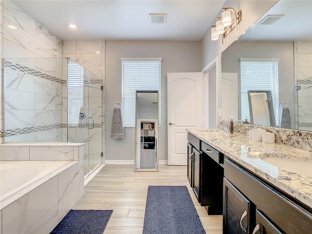 260 Teddy Rushing St, Debary, FL 32713 - bathroom with double vanity, a sink, a garden tub, and a stall shower