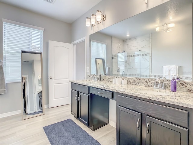 260 Teddy Rushing St, Debary, FL 32713 - full bathroom featuring wood finished floors, double vanity, a sink, and a stall shower