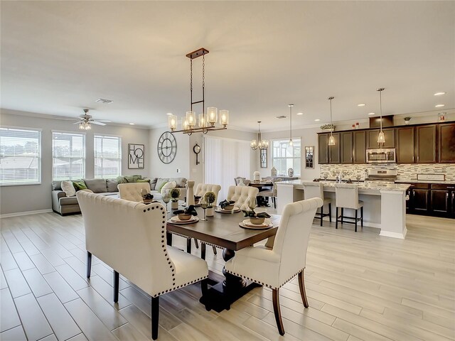 260 Teddy Rushing St, Debary, FL 32713 - dining area featuring visible vents, ornamental molding, recessed lighting, light wood finished floors, and ceiling fan with notable chandelier