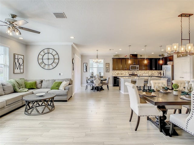 260 Teddy Rushing St, Debary, FL 32713 - dining area with visible vents, crown molding, recessed lighting, light wood-type flooring, and ceiling fan with notable chandelier