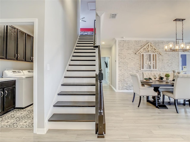 260 Teddy Rushing St, Debary, FL 32713 - stairs with independent washer and dryer, visible vents, wood finished floors, baseboards, and a notable chandelier