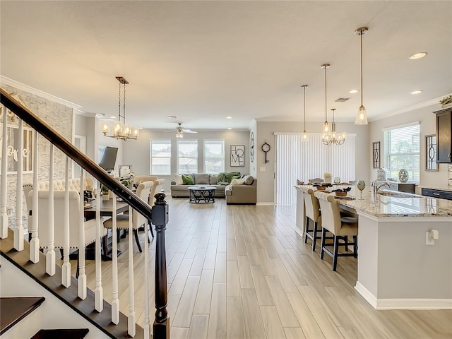 260 Teddy Rushing St, Debary, FL 32713 - interior space with crown molding, a wealth of natural light, light stone countertops, and a kitchen bar