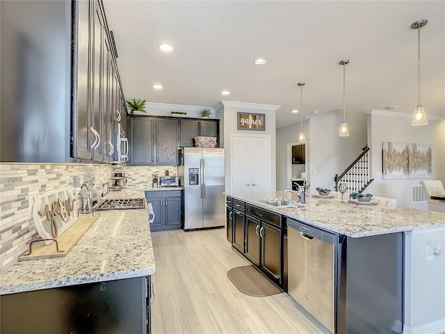 260 Teddy Rushing St, Debary, FL 32713 - kitchen featuring tasteful backsplash, a center island with sink, a sink, ornamental molding, and stainless steel appliances