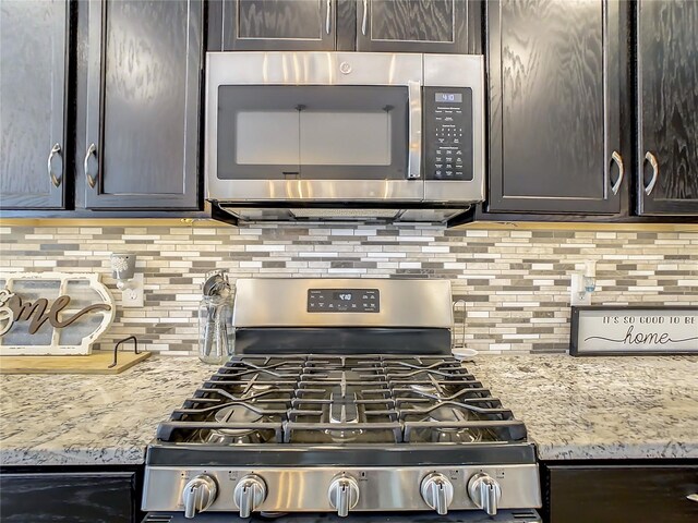 260 Teddy Rushing St, Debary, FL 32713 - kitchen with light stone counters, backsplash, stainless steel appliances, and dark brown cabinetry