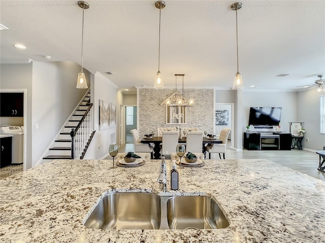 260 Teddy Rushing St, Debary, FL 32713 - kitchen featuring crown molding, light stone countertops, washer / clothes dryer, a ceiling fan, and open floor plan