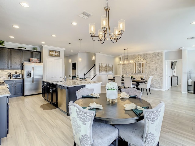 260 Teddy Rushing St, Debary, FL 32713 - dining room featuring visible vents, light wood finished floors, a notable chandelier, ornamental molding, and recessed lighting