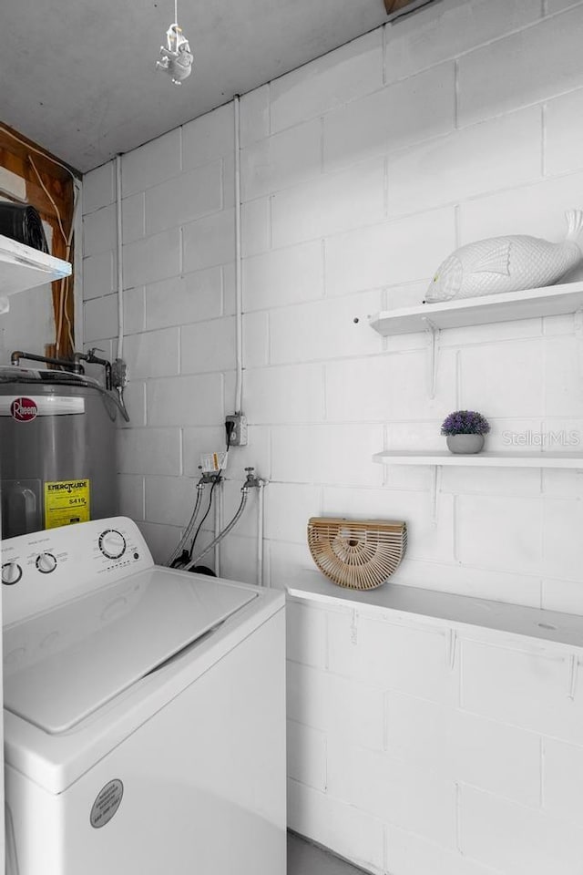 laundry area featuring water heater, laundry area, and washer / dryer